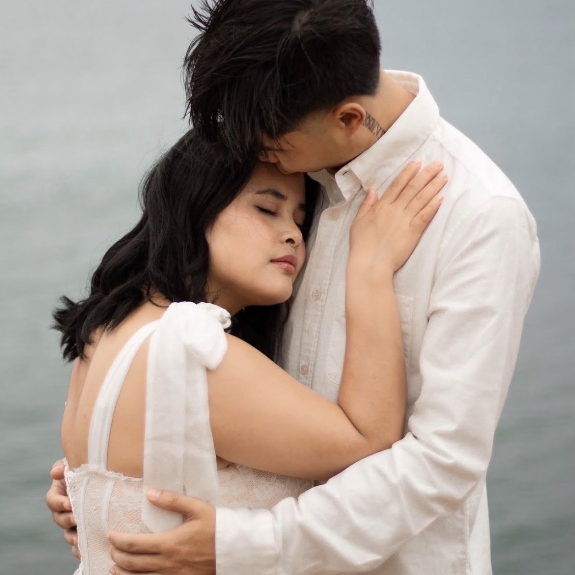 Couple embracing by the ocean